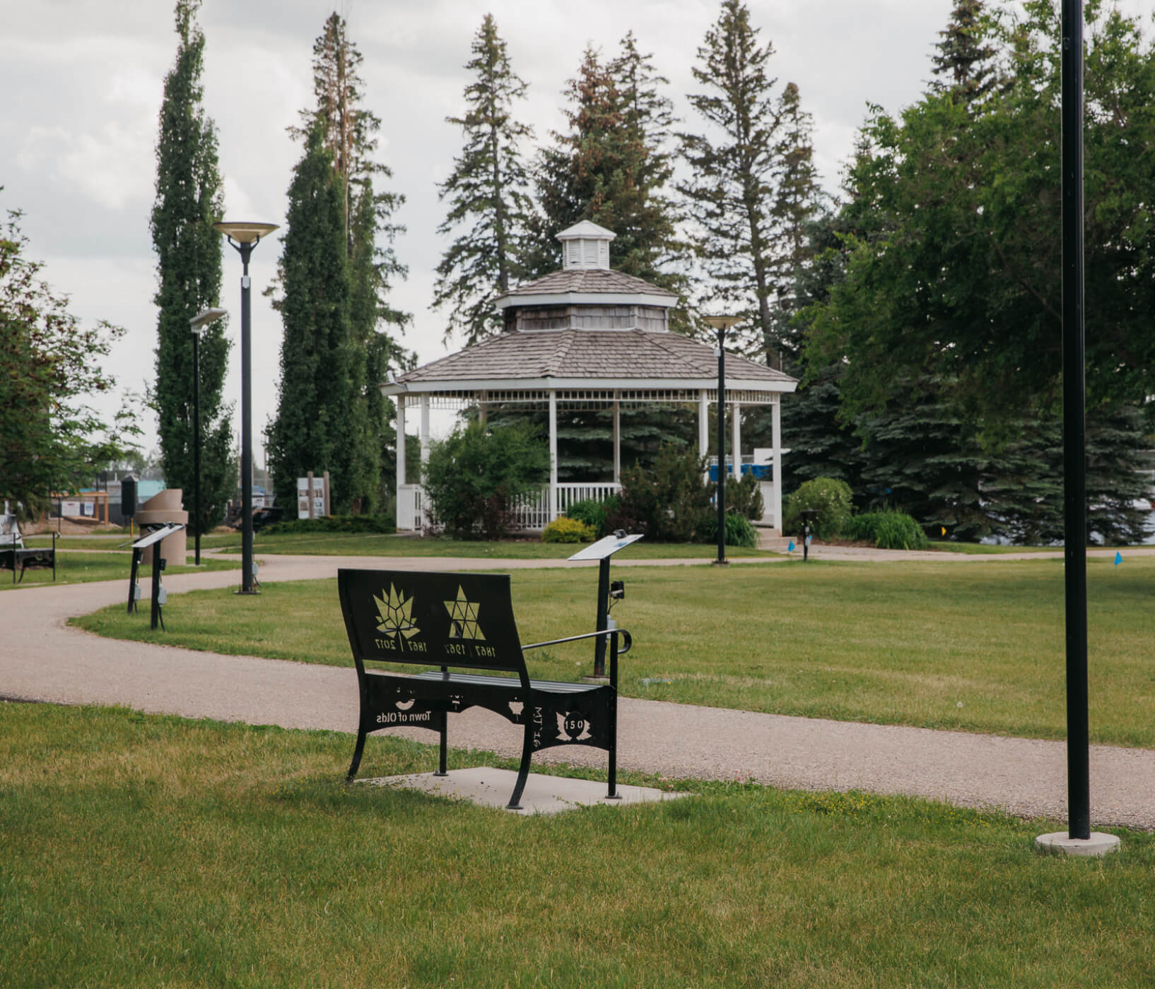 A bench and gazebo in Centennial Park in Olds, Alberta