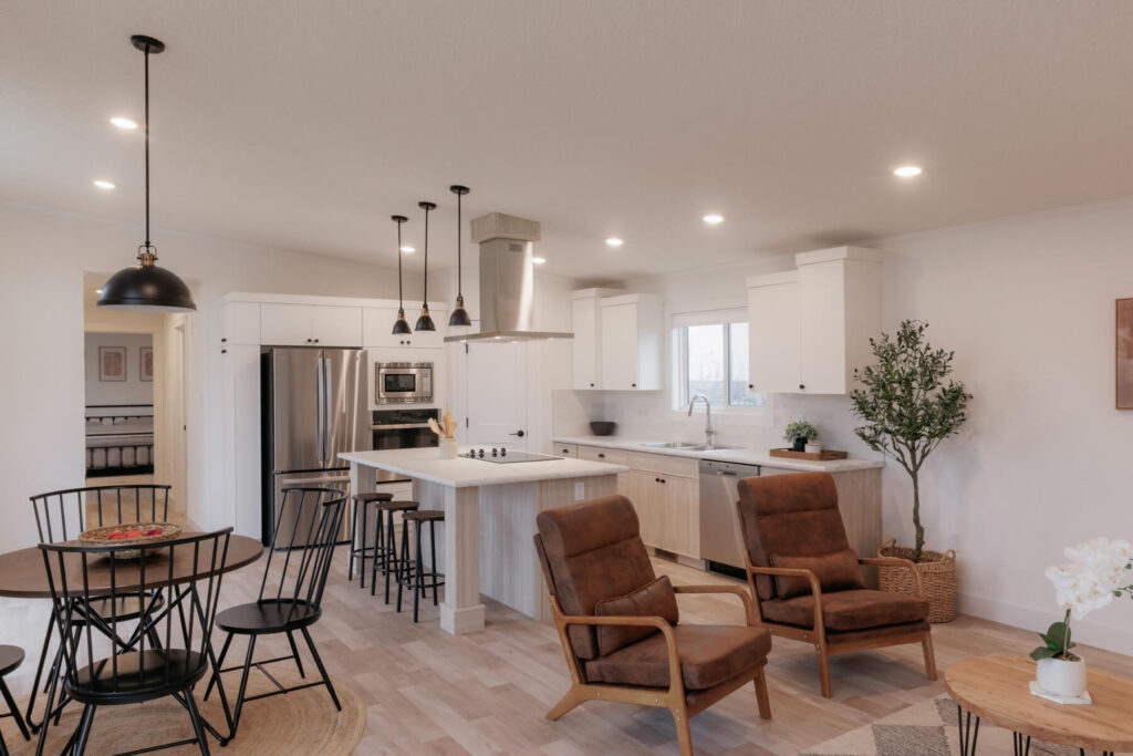 Interior photo of the open concept kitchen, dining room and living room in The Tamarack Floorplan
